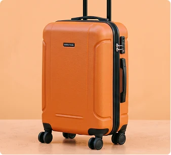 Orange carry-on suitcase on an orange background