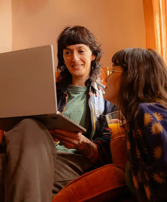 Two people looking at a laptop together