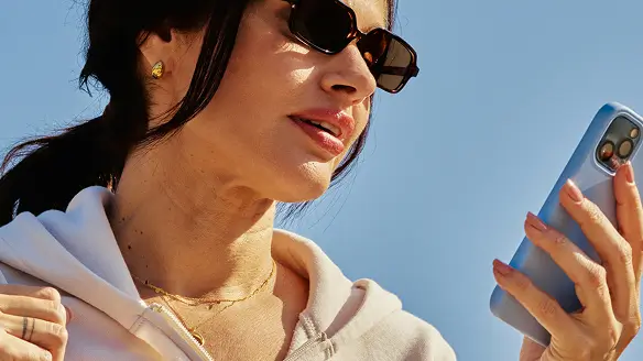 Person in sunglasses looking at a phone