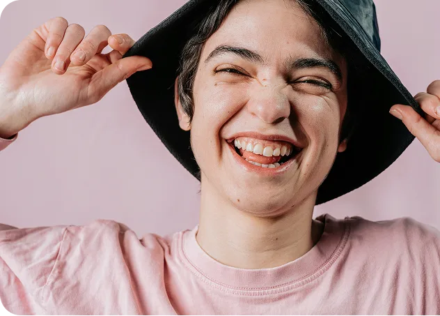 Smiling person in hat