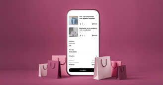 Mobile phone displaying a digital shopping cart with fashion items, including a blue oversized hoodie and white chunky sneakers, surrounded by pink and purple shopping bags on a pink background.