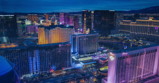 A panoramic night view of the Las Vegas skyline, the host city for Shoptalk, highlighting the bright lights and major hotel landmarks along the Strip.